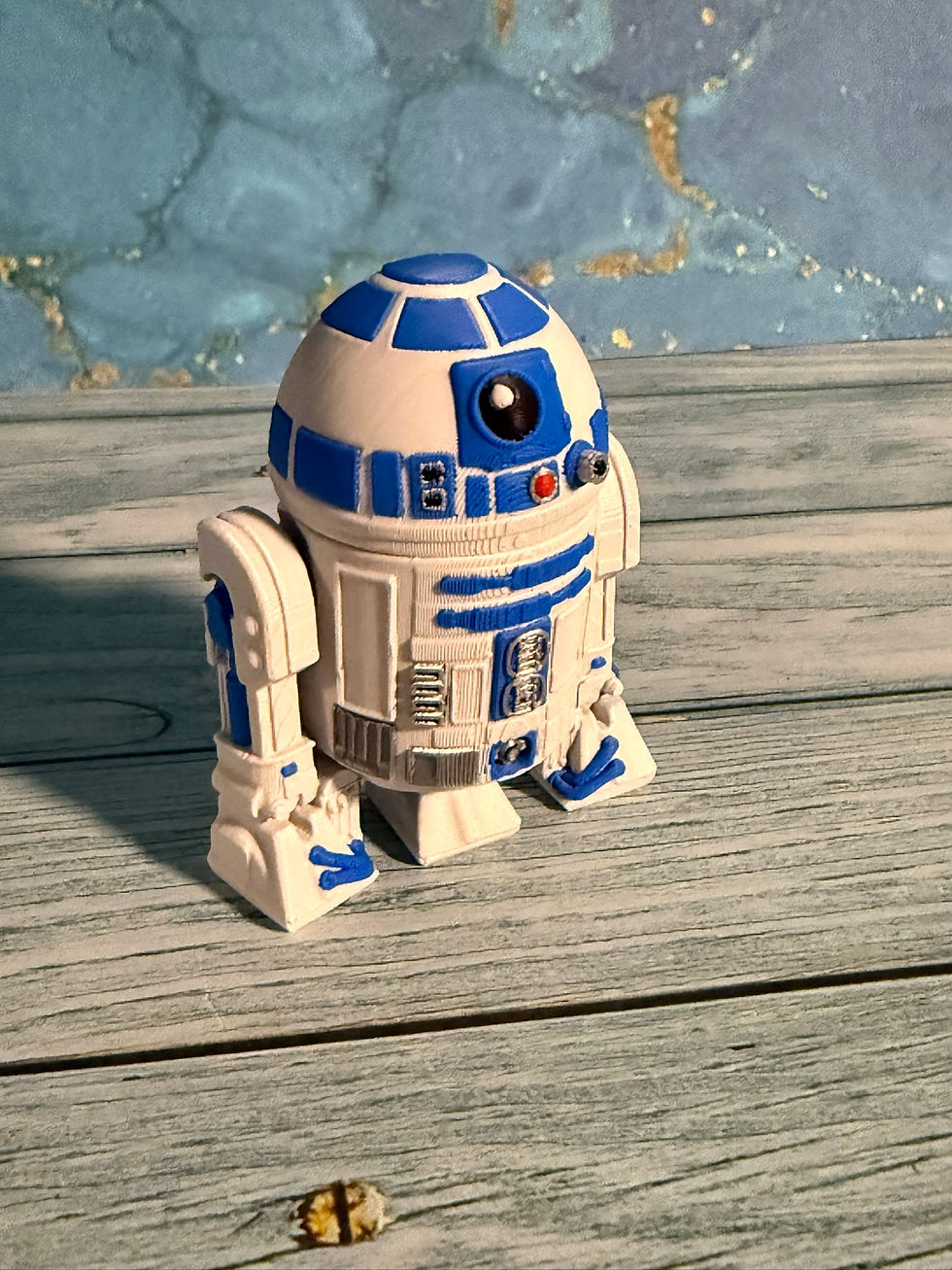 Blue-and-white 3D-printed Galactic Droid figure with detailed mechanical panels and a dome-shaped head.