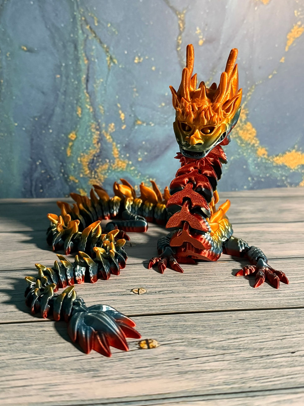 Thumbnail: Articulated imperial dragon figurine with long serpentine body in red and gold tones on display