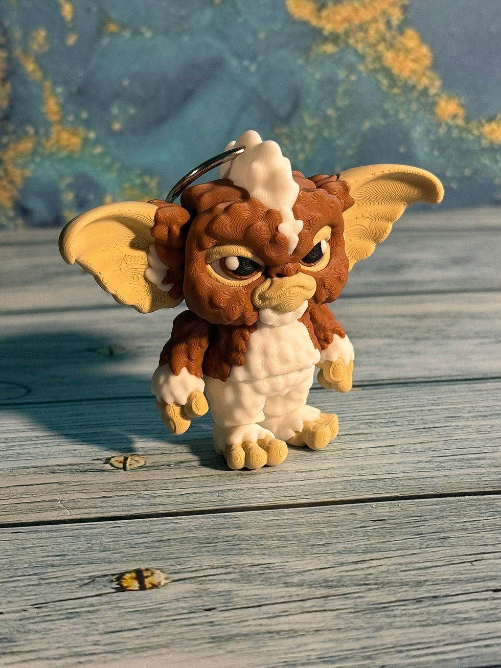 Thumbnail: 3D printed Chaos Fang fantasy creature keychain with oversized ears and mischievous expression displayed on wooden background