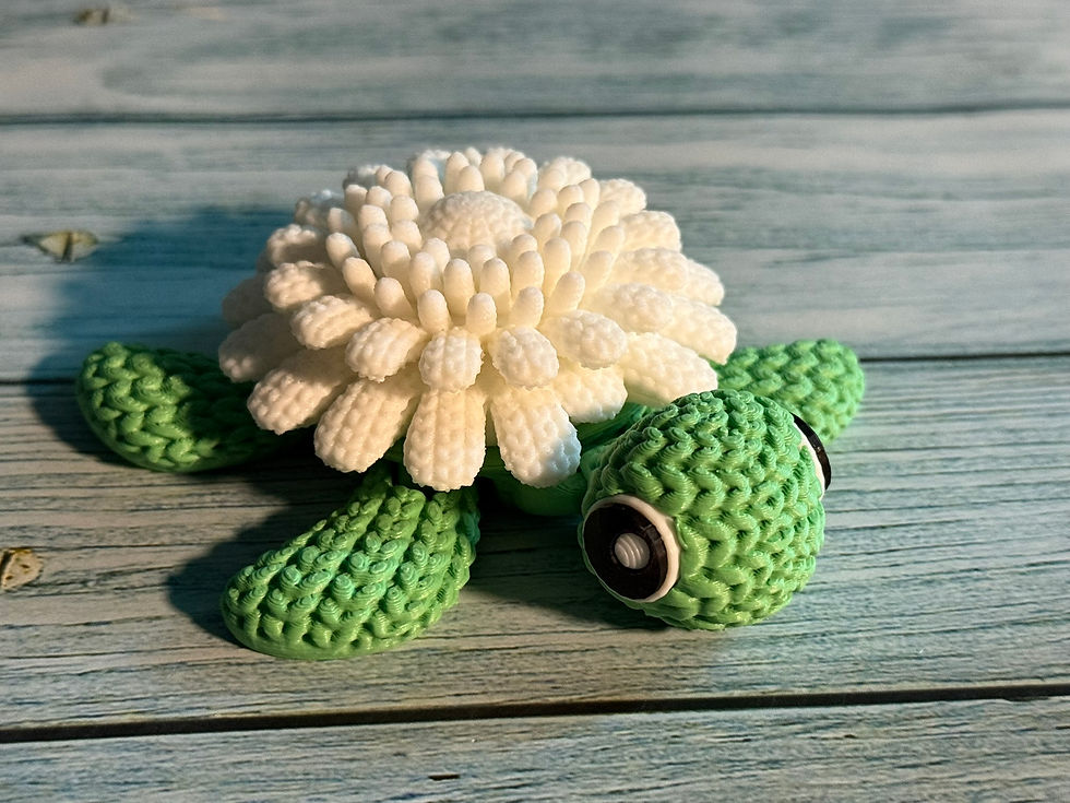 White flower turtle with daisy-inspired shell and green crochet-style texture sitting on a stone garden path.