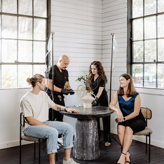 group of friends getting iv hydration therapy at a table