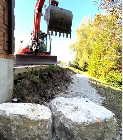 Excavation services in Oshawa by Estate Landscaping, featuring a professional excavator clearing land for a landscaping proje