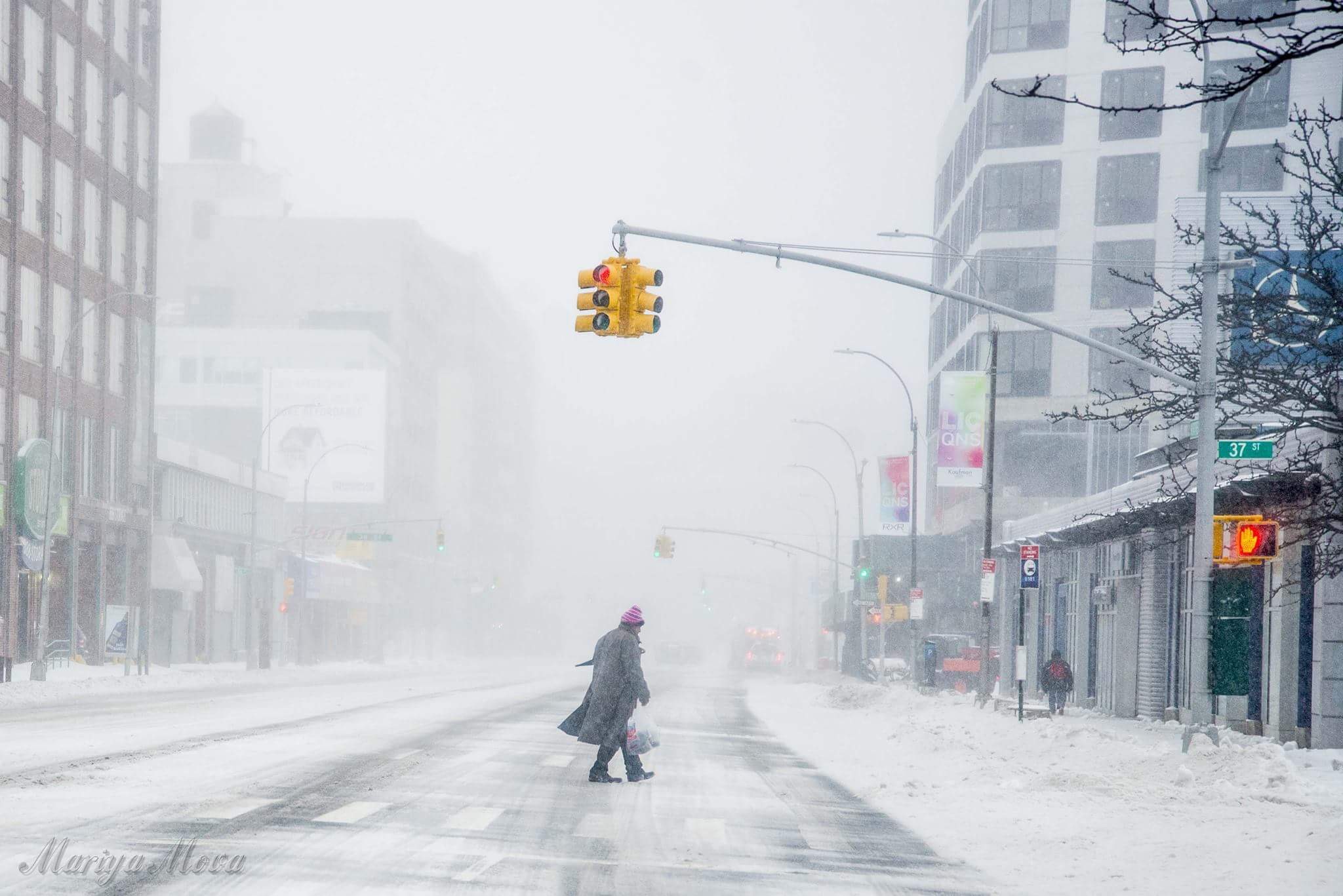 Man crossing snowy road by Mariya Mo