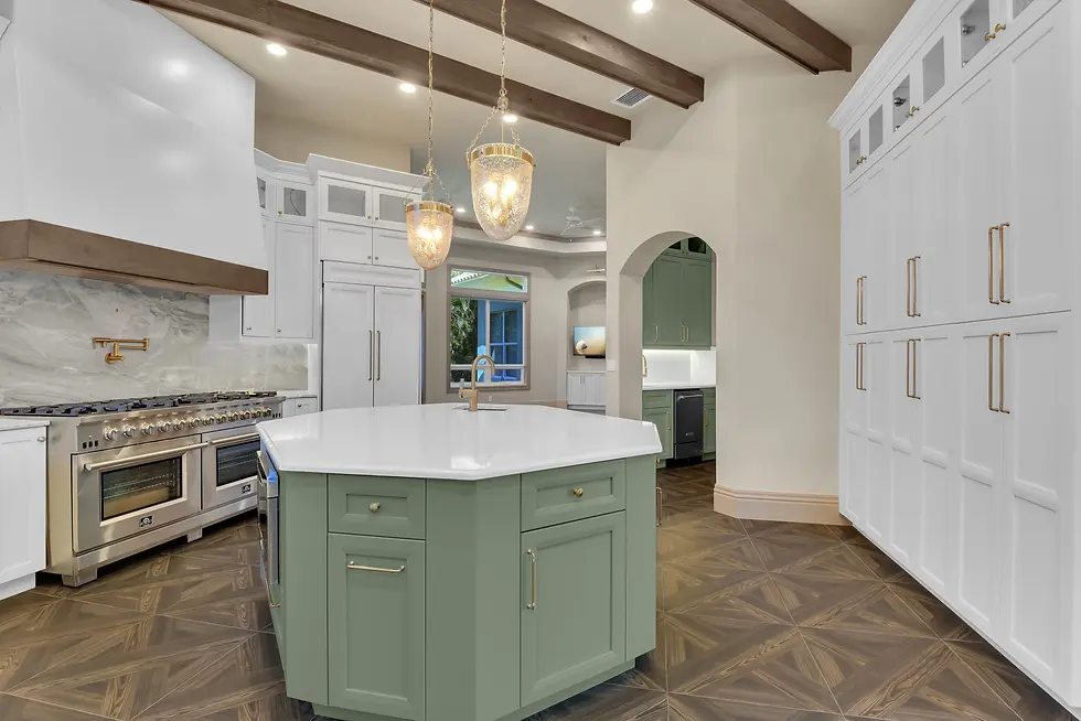 Full Kitchen Remodel in Naples, Florida with stone-top green island, floor to ceiling cabinets, and beautiful chandalier