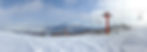 The top of an empty ski slope with a chair lift alongside it in Niseko, Japan