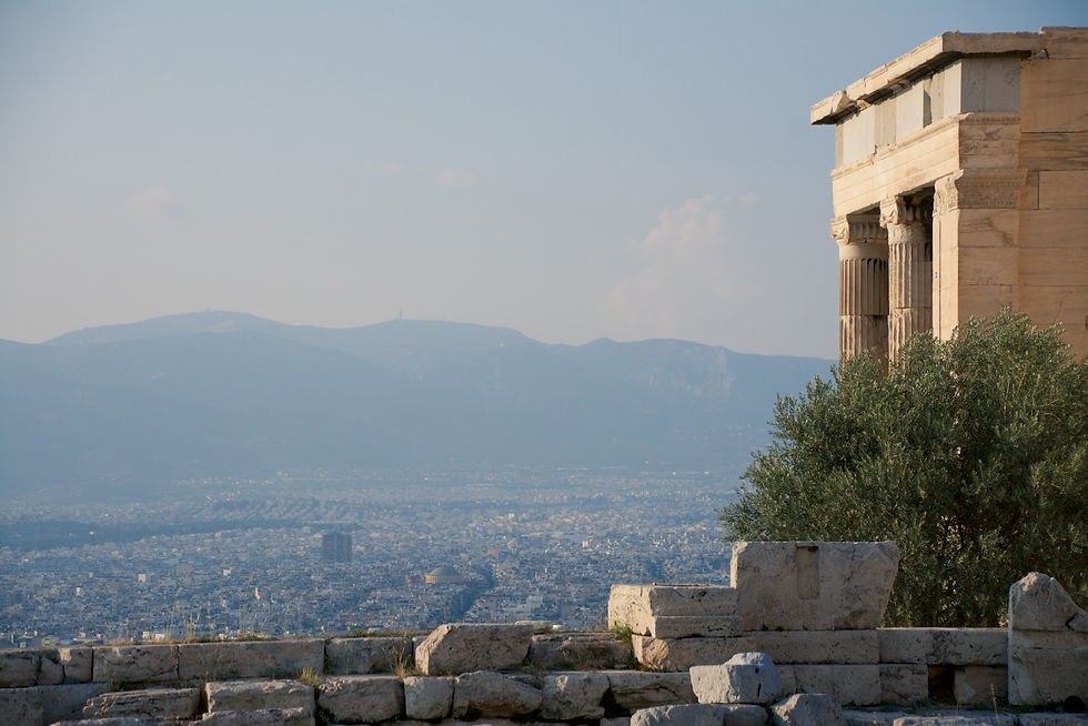 The Erechtheion on the Acropolis of Athens with the city and mountains in the distance