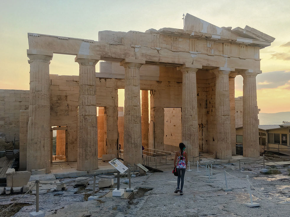Eryn walks towards the Propylaia of the Acropolis of Athens at sunset