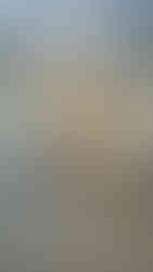 A carved statue of a sphinx, a winged lion with a woman's head, sitting on a pedestal in the Archaeological Museum of Delphi, Greece