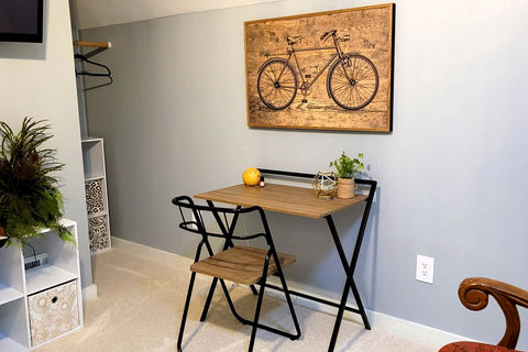 The Grayson B&B +Extended Stays | Baker Suite writing desk under bicycle art | the Eastside