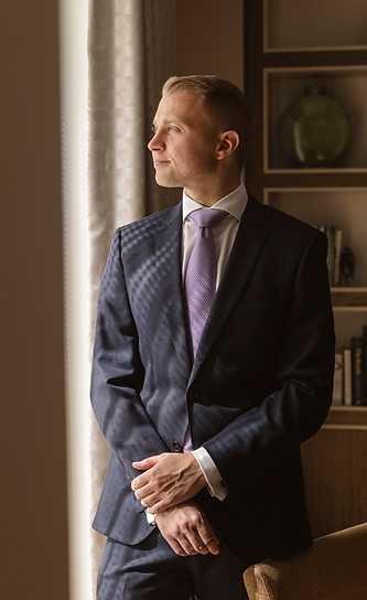 Stefan Schöning, Luxury Household Management Consultant, standing at a window in a private residence