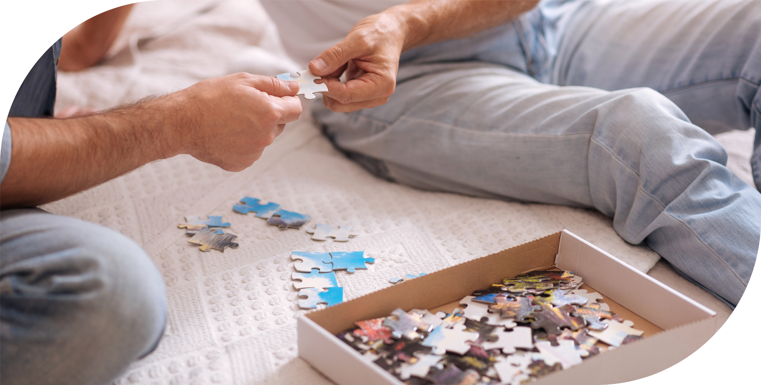 Two men holding a puzzle piece.