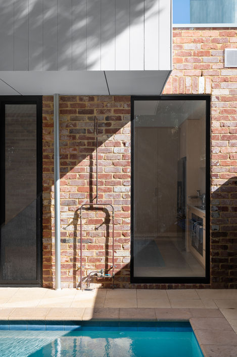 Architectural Photography Exterior mixed materials, recycled brick, vertical board over hung extension, exposed pipe.