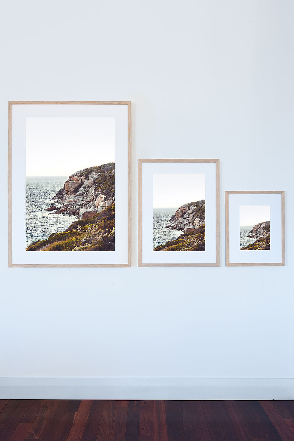 Thumbnail: Winter, photographic print of rocky coastline and inky blue ocean. Framed in Tasmanian Oak, three sizes Large, Medium, small.
