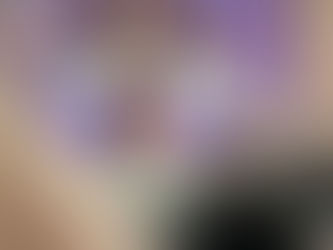 Young person sat on sofa smiling