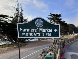 Sign advertising the farmers market. Copyright 2026 Tara Leweling