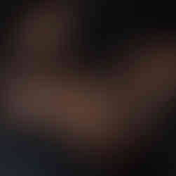 Client laughing and relaxed during a candid boudoir experience moment