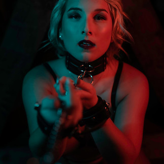 Creative boudoir portrait with colored lighting during a styled boudoir experience