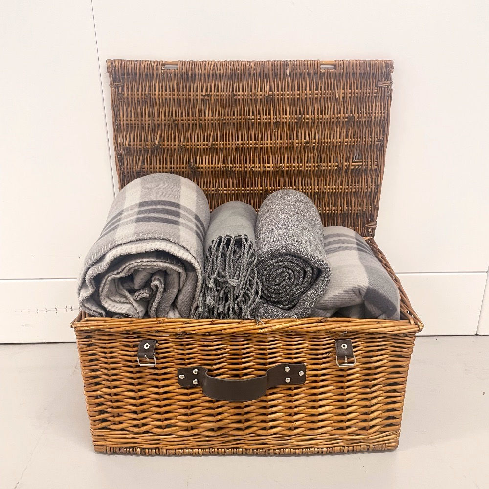 Picnic basket with a mix of grey blankets