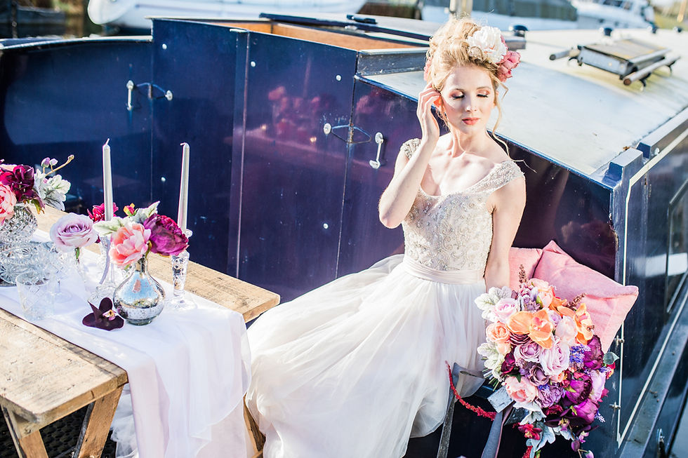 Contemporary bride marrying outdoors on a narrowboat on the British canal waterways. Colour bock wedding bouquet created by Miss Fleur Floral. Dresses by Bridal Reloved Maldon
