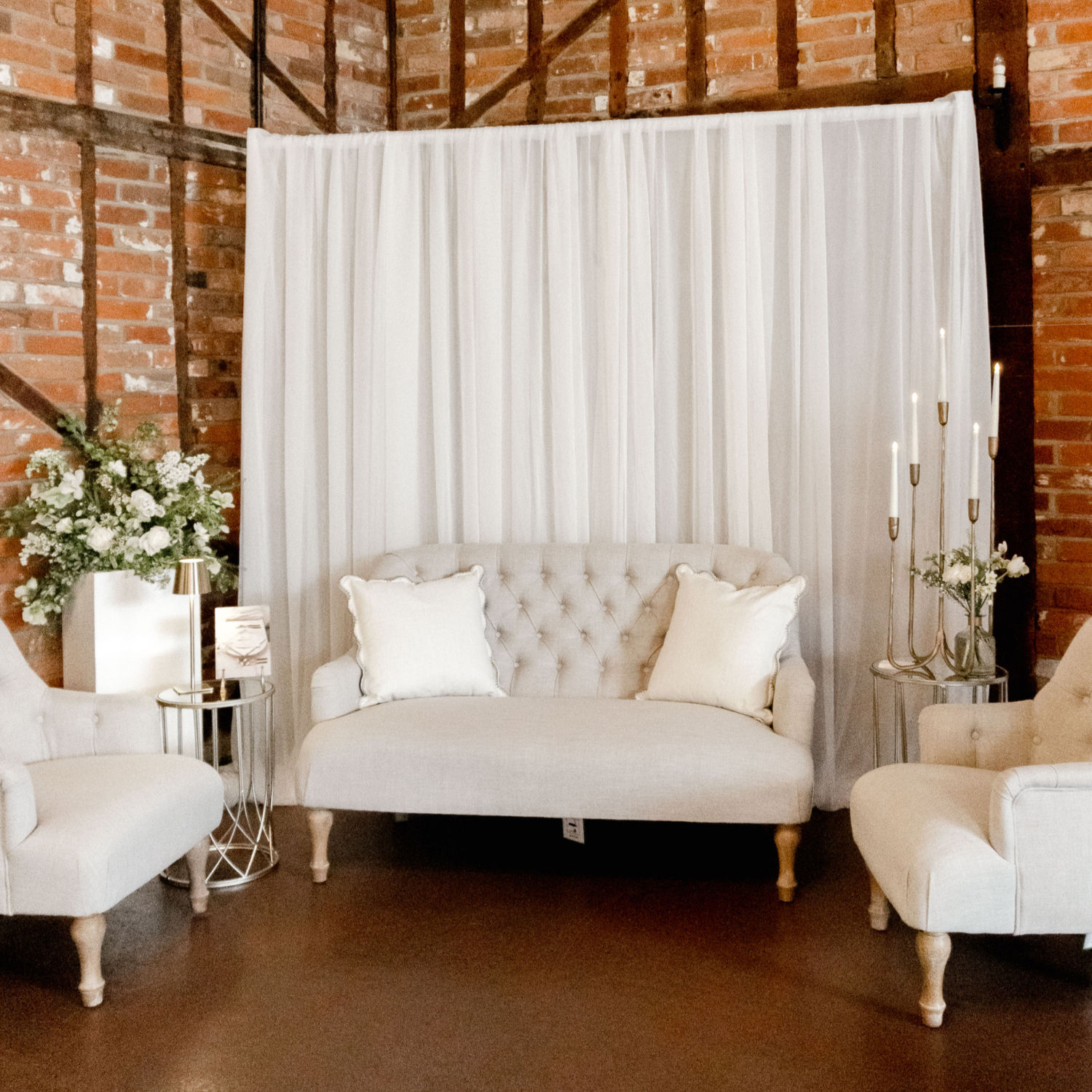 Simple lounge set in fabric linen with draped backdrop