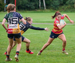 Female Rugby Player Dodging a tackle