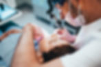 dentist performing root canal on female patient
