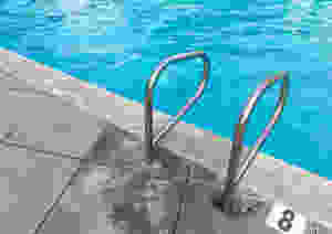 Swimming pool ladder handrail at deep end