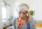 woman trying to smell grapefruit looking upset