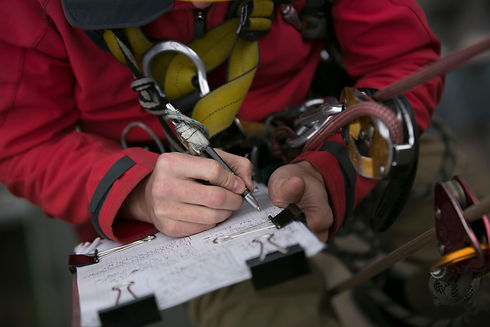 Close up picture of rope access technician engineer worker writing a report of building st