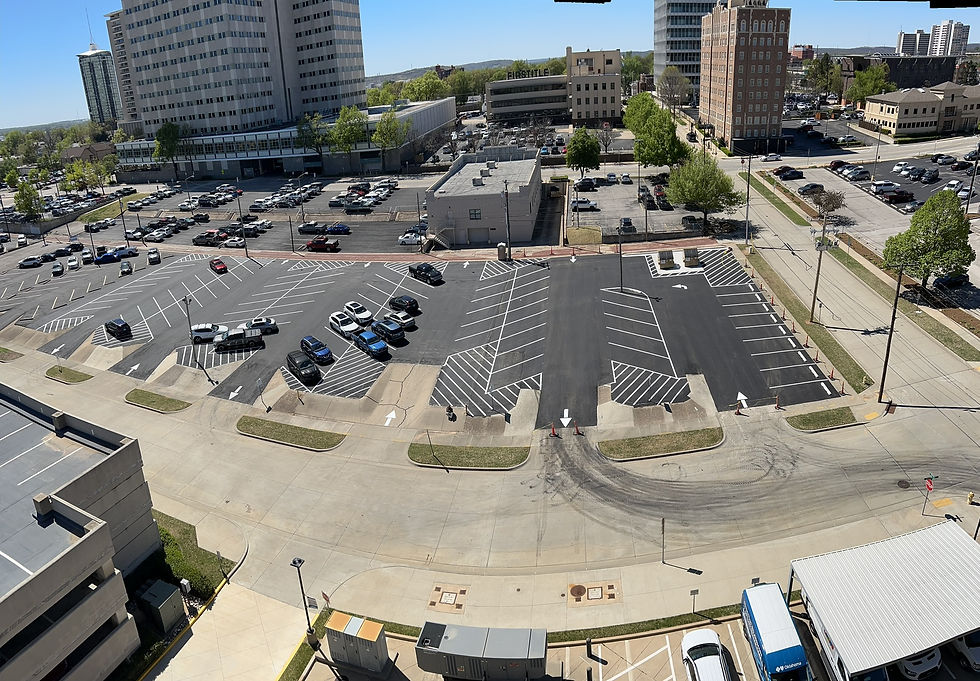 Ellsworth employees next to a redone parking lot.