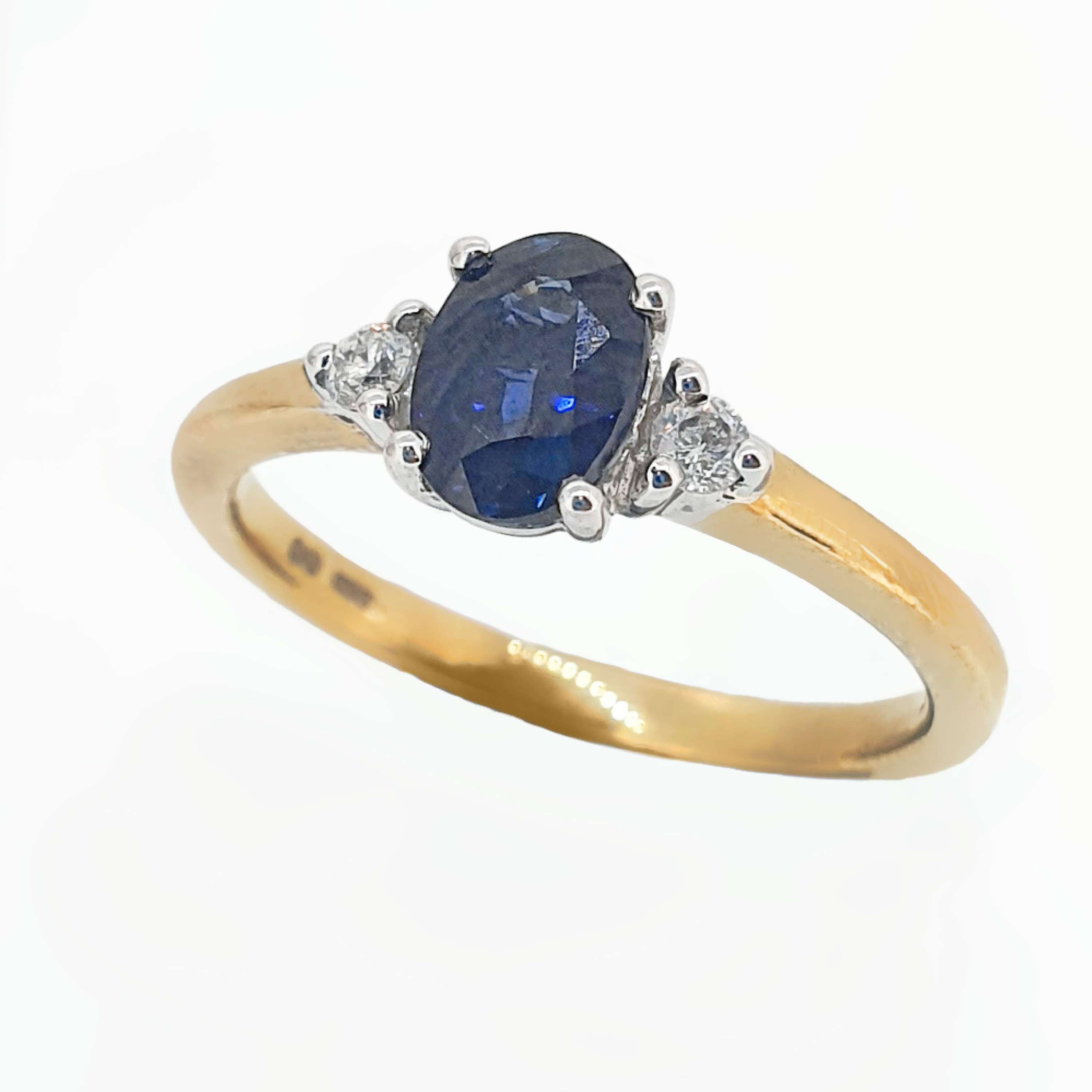 Oval Sapphire and Diamond Three Stone Engagement Ring Set In 9 Carat Yellow Gold