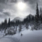 The sun peeking through the clouds on a moody day at Bow Summit, Banff National Park