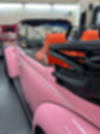 Side shot of Pink VW Beetle electric conversion by Retroelectric featuring tangerine interior