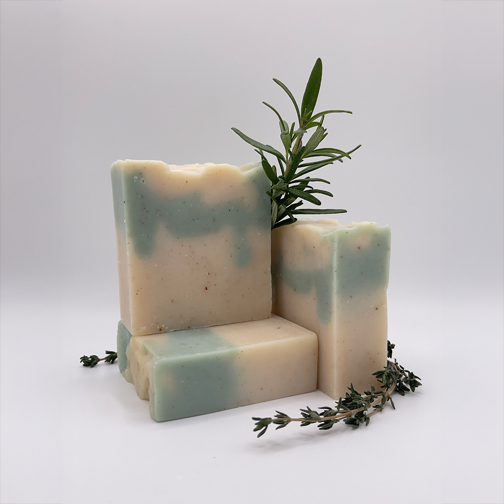 Rosemary Thyme Bar Soap, stack of soap with sprigs of fresh rosemary and thyme