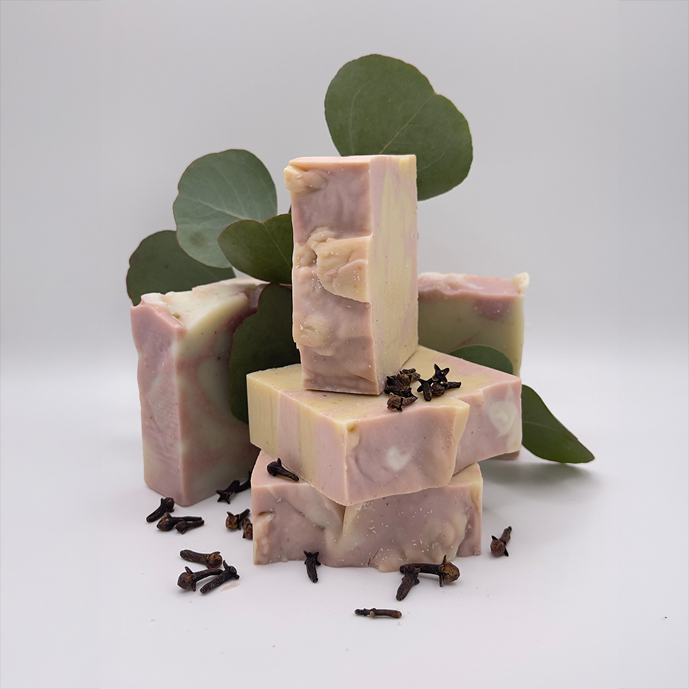 Eucalyptus Clove product image, stack of soap view with eucalyptus leaves and clove