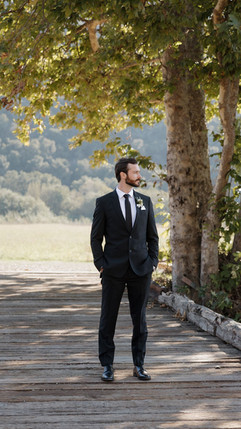 Groom portrait on bridge prior to wedding ceremony at Tar Creek Ranch by SLO Wedding Photographer