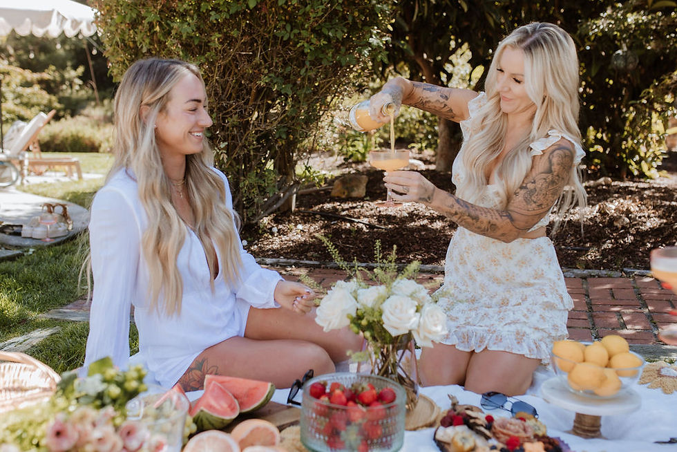 Girls at Bachelorette party picnic pouring mimosa for Bahama Mamas Spray Tanning