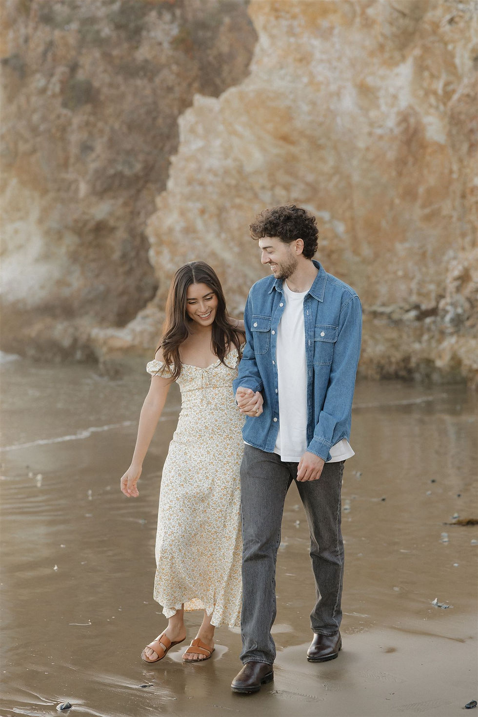 Walking hand-in-hand on Pismo Beach engagement photos by MacKenzie Rana Photography
