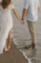 Ally and Anthony walking hand in hand during Morro Bay engagement session by MacKenzie Rana Photography