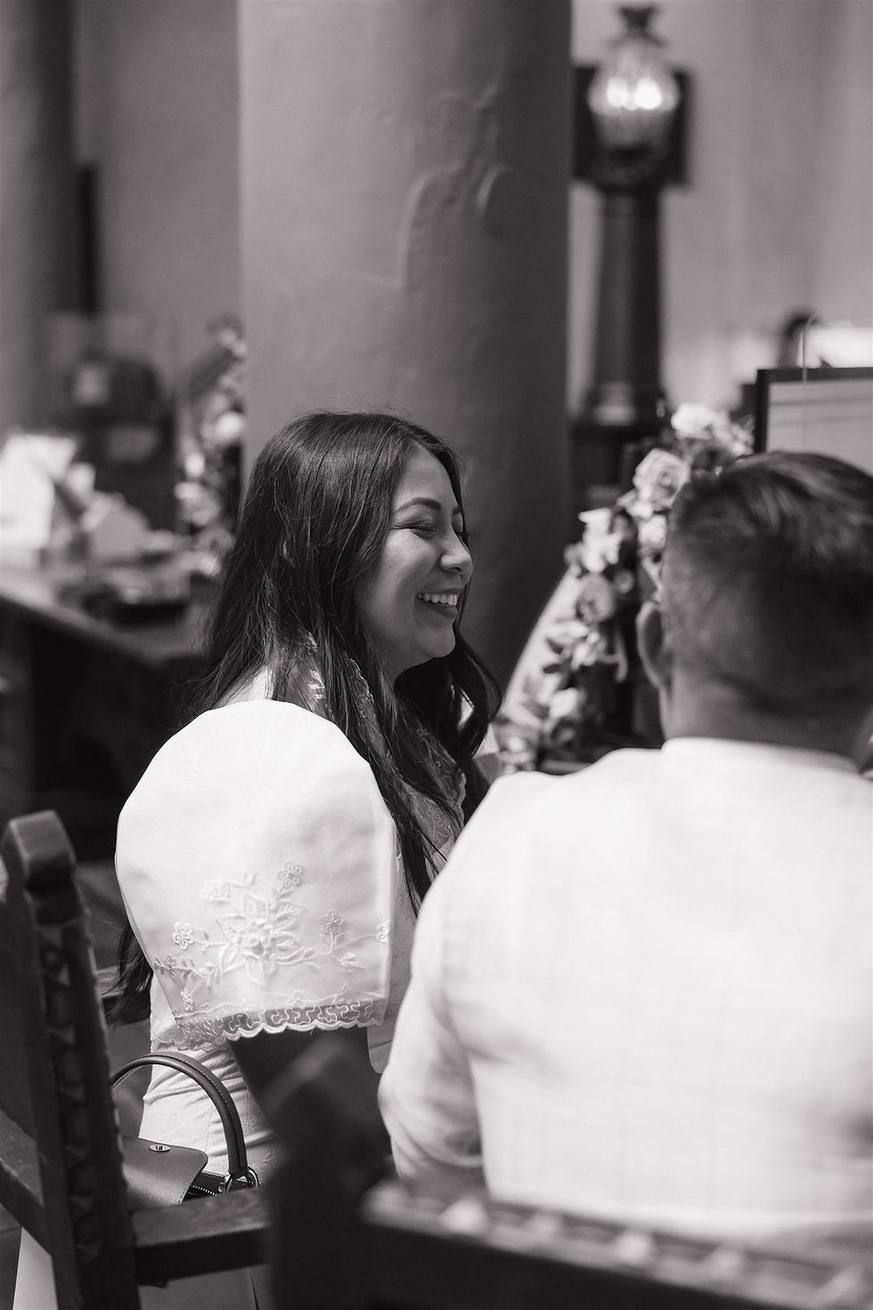Bride smiling during Santa Barbara Courthouse ceremony by MacKenzie Rana Photography in black and white.
