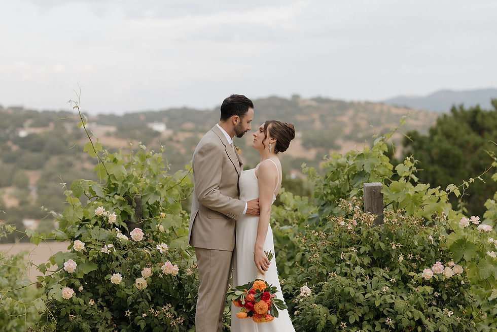 San Luis Obispo Wedding Photographer capturing bride and groom near greenery at Casitas Estate during Wedding.