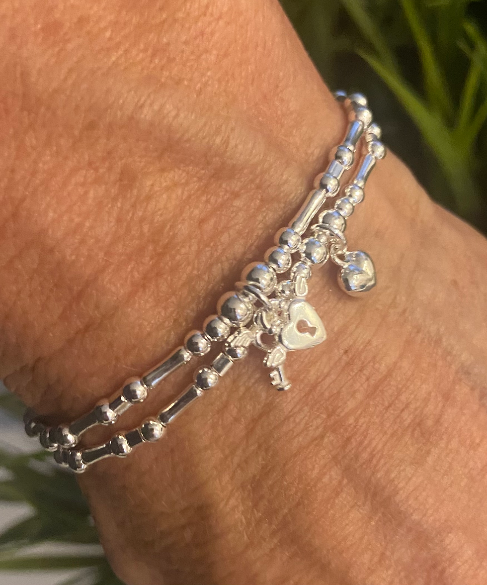 Thumbnail: Silver Angel Wing Lock & Key Stacking Bracelet on the wrist