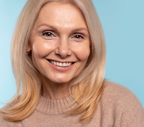 senior-woman-smiling-against-blue-background-low-15.jpg