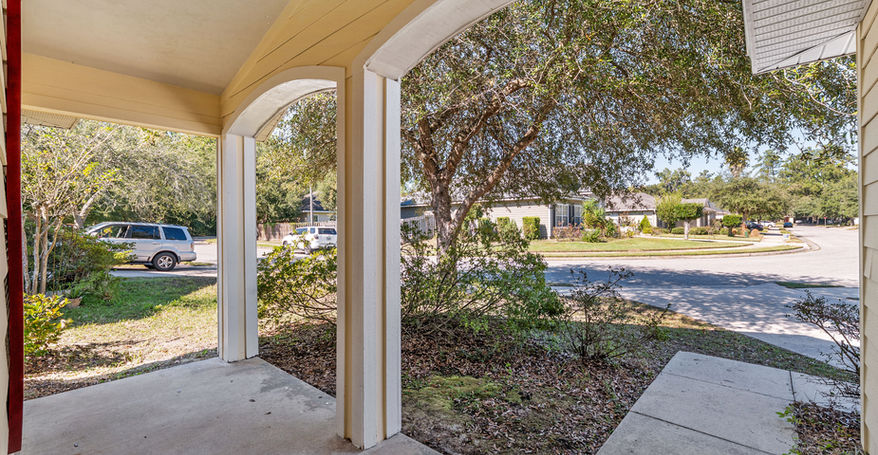 View of the street and yard from under the home's porch
