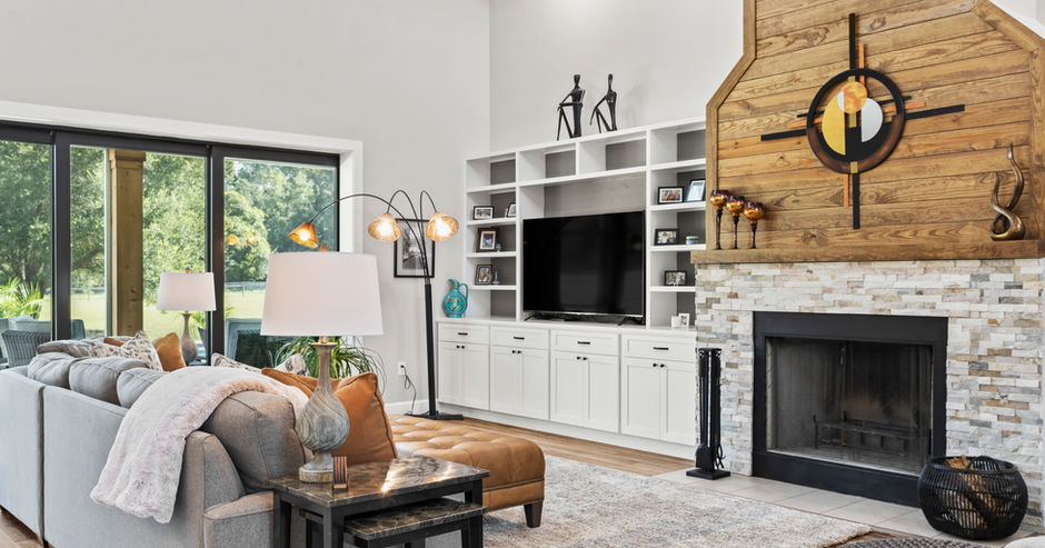 Elegant living room with fireplace, TV, and modern decor. Spacious and bright.