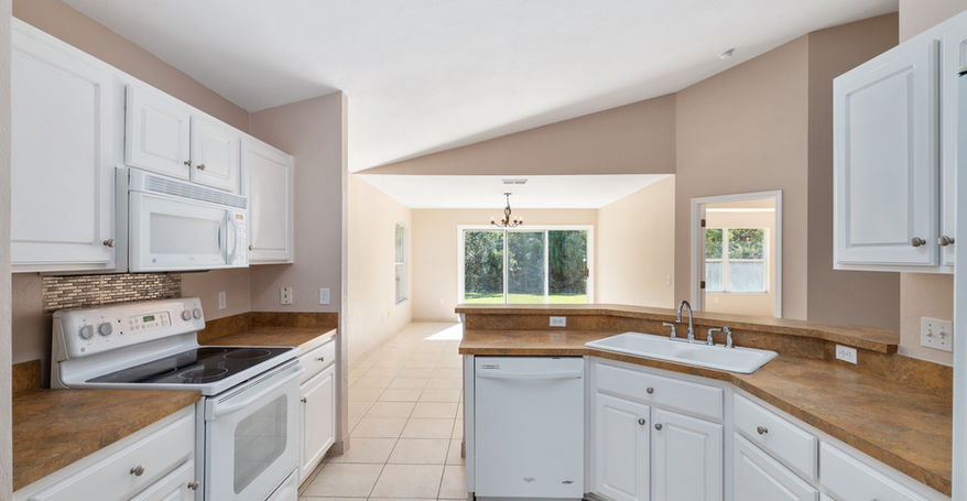 White kitchen interior with appliances and view to the Sorrento home $299,900.