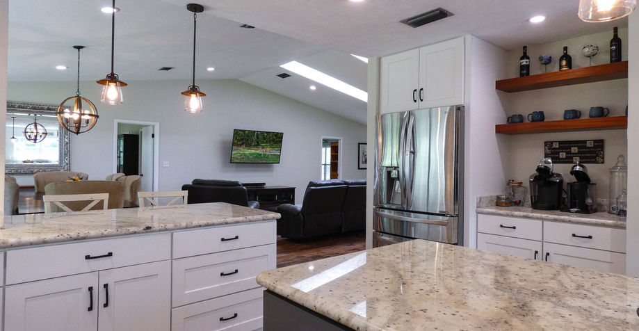 Modern kitchen with white cabinets and granite countertops with open concept layout