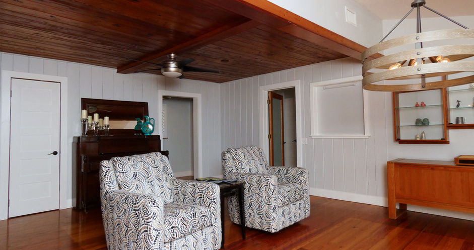 Cozy living room with two patterned armchairs and hardwood floors