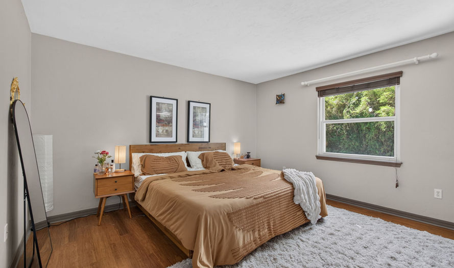 Modern bedroom at Royal Gardens with tan bedding