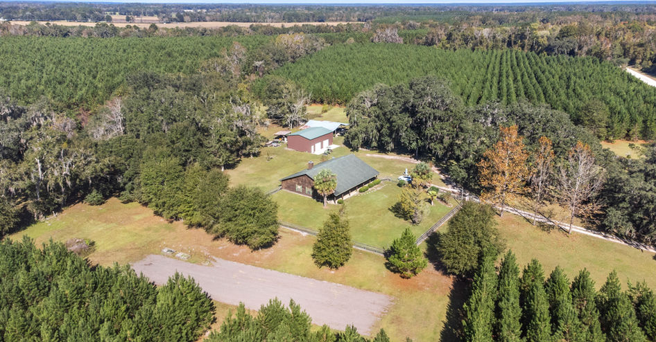 Aerial view of property with green roof and Alachua 33.45 Acres $720,000